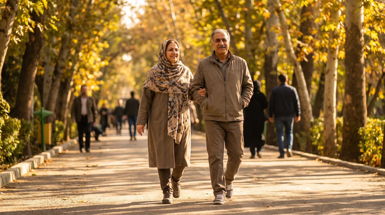 زوج میانسال در حال پیاده‌روی در مسیر درختی پارک؛ فعالیت بدنی منظم برای مراقبت از عروق قلب